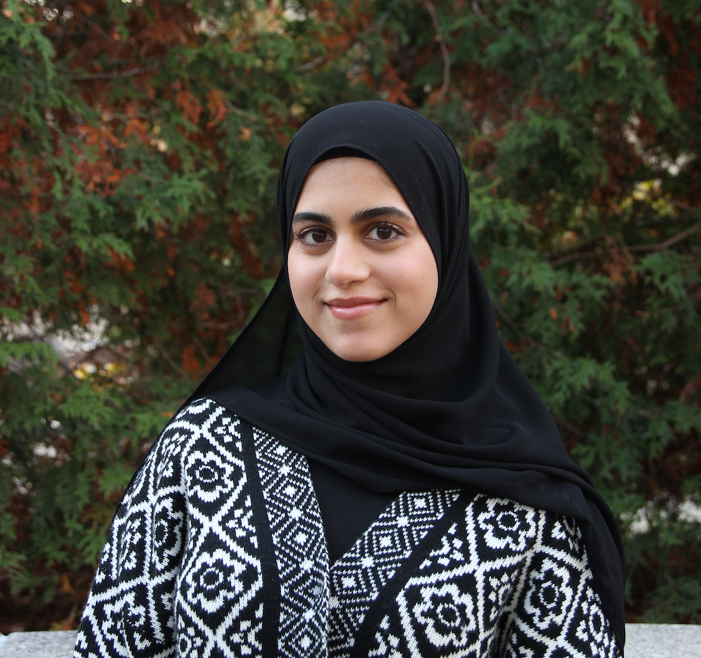 Warisha, a hijabi with dark brown eyes, smiling