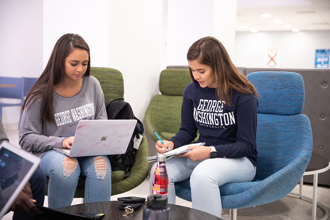 2 students working on a laptop together