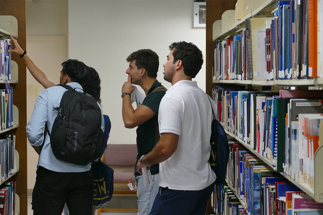 Students looking for books at Himmelfarb library