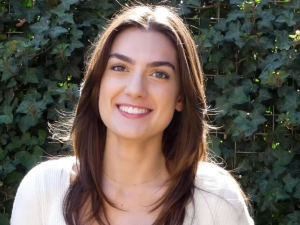 Amaryllis, a young woman with dark brown hair, smiles at the camera.