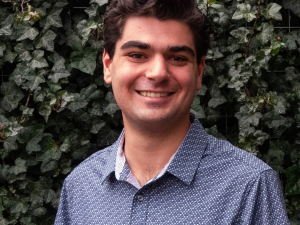 Nathaniel, a young white man with dark hair and brown eyes, smiling
