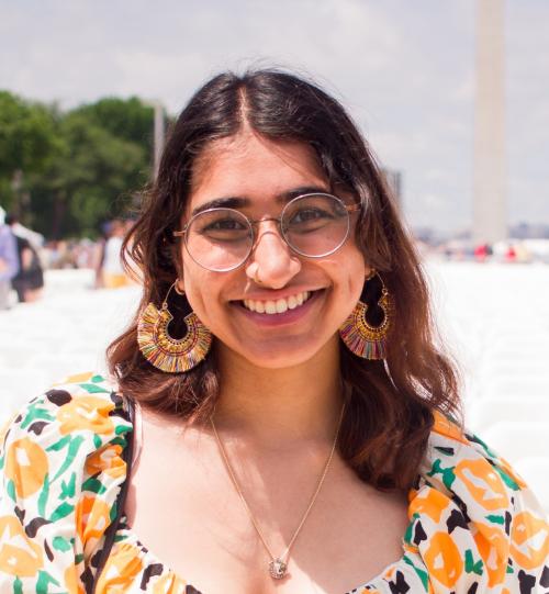 Shree, a young Indian woman with brown hair, smiling.