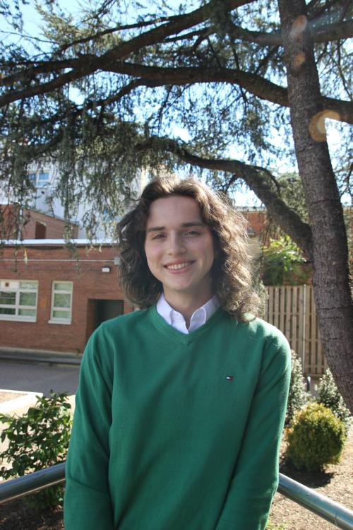 Maggie, a brunette woman smiling facing the camera squarely