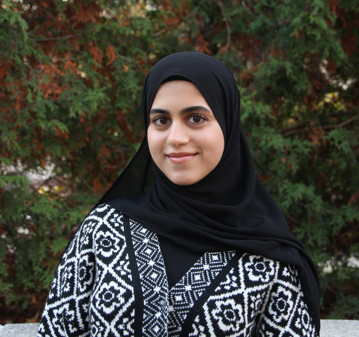 Warisha, a hijabi with dark brown eyes, smiling